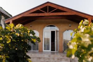 a building with a white door and windows at KISLOV Vineyard Boutique Hotel in Hagimus