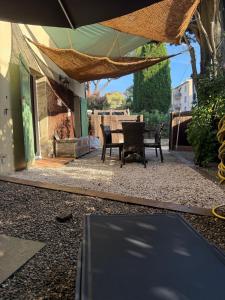 a patio with two chairs and a table at Charming garden apartment Lorettes in Saint-Tropez +2 photos