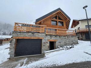 a house with a garage in the snow at Le val'heureux in Valloire