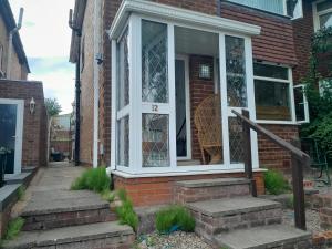 a front door of a brick house with stairs at mapa in Birmingham