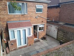 a brick house with a door and a window at mapa in Birmingham +13 photos