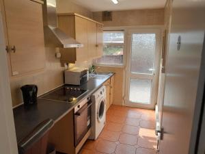 a kitchen with a sink and a stove top oven at mapa in Birmingham