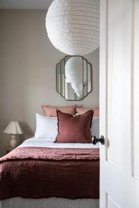 a bedroom with a bed with a mirror on the wall at Little Elizabeth in West Hobart