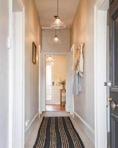 a hallway with a door and a rug at Little Elizabeth in West Hobart