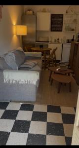 a living room with a couch and a table at Charming garden apartment Lorettes in Saint-Tropez
