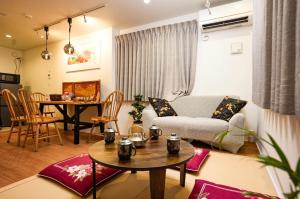 a living room with a couch and a table at 和モダン福 名古屋駅徒歩8分 最大10名 一軒家貸切 寝室3 in Minami-sotoborichō