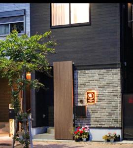 a building with a sign on the side of it at 和モダン福 名古屋駅徒歩8分 最大10名 一軒家貸切 寝室3 in Minami-sotoborichō