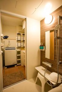 a small bathroom with a shower and a sink at 和モダン福 名古屋駅徒歩8分 最大10名 一軒家貸切 寝室3 in Minami-sotoborichō +54 photos