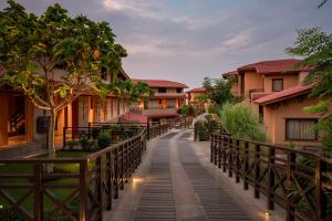 a walkway through a resort with buildings at AamaGhati Wildlife Resort, Ranthambore in Sawāi Mādhopur