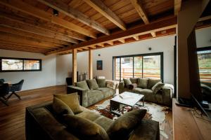 a living room with two couches and a tv at Le val'heureux in Valloire