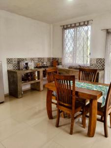 a dining room with a table and chairs at Casa Imox in Bacalar