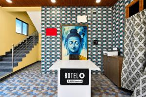 a hotel lobby with a painting of a woman at Hotel O Shadnagar Formerly Sri Jogulamba Residency in Bālānagar