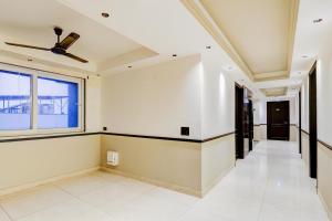 an empty hallway in a house with a ceiling fan at Super Townhouse Oak Udyog Vihar in Gurgaon +39 photos