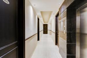 a hallway with black and white walls and a door at Super Townhouse Oak Udyog Vihar in Gurgaon