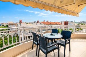a patio with a table and chairs on a balcony at 3 Bedroom Apartment, Easy Parking in Alexandroupoli