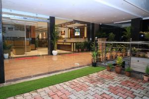 a lobby of a building with plants in it at Hotel New JMK in Katra