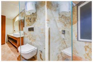 a bathroom with a shower and a toilet and a sink at Super Townhouse Oak Udyog Vihar in Gurgaon