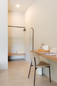a dining room with a table and a chair at The Cozy Hotel in Phetchaburi +42 photos