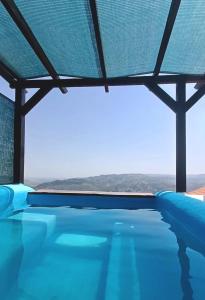 a swimming pool with a view of the ocean at Bela Vista in Paradela