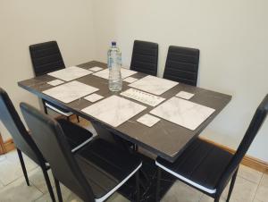 a table with a bottle of water sitting on top at Tunmobi Gardens Apartment in Ballyjamesduff