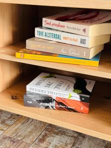 a stack of books sitting on a shelf at Siedlisko in Tuchów