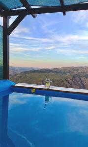 a drink sitting on the edge of a swimming pool at Bela Vista in Paradela +30 photos