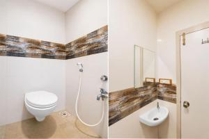 a white bathroom with a toilet and a sink at Hotel O Sabarmati Ashram Ahmedabad Formerly Red Apple in Ahmedabad