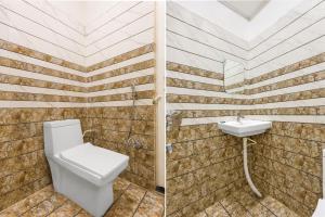 a bathroom with a toilet and a sink at Collection O Rajgir Railway Station Formerly Hotel Swastik in Ekangar Sarai