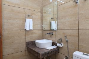 a bathroom with a white sink and a shower at Hotel New JMK in Katra +39 photos