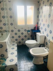 a bathroom with a white toilet and a sink at La Bienvenue in Tourtrol +49 photos