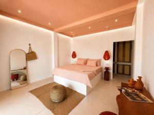 a bedroom with a bed and a mirror at Navi - Boutique Hotel - Adults Only in Ahangama