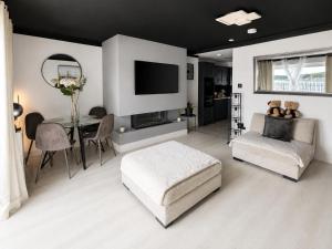 a living room with a couch and a table with a television at SeaView Apartment Suite in Cobh