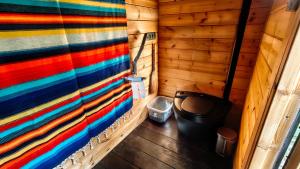 a room with a colorful wall and a trash can at Rivergold Cottage in Ivalo +19 photos