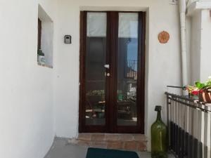 a wooden door on a building with a window at La Casa di Anna'80 in SantʼArcangelo