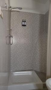 a bathroom with a shower with a tub and a sink at La Casa di Anna'80 in SantʼArcangelo
