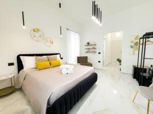 a bedroom with a large bed with a stuffed animal on it at Bosa Centro Rooms in Bosa