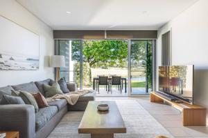 a living room with a couch and a table at 3BR Golfside Villa | Pools, Tennis & Relaxation in Magenta