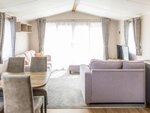 a living room with a couch and a table at Luna - Ukc9719 in Aston