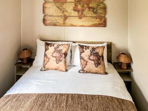 a bed with two pillows and a map on the wall at Luna - Ukc9719 in Aston +2 photos
