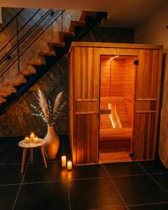 a sauna with a staircase and a table with candles at Symbiose hotel in Charleroi