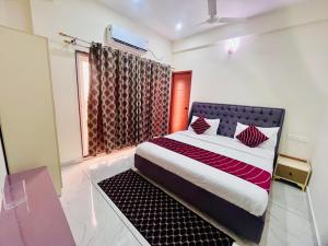 a bedroom with a bed and a window at Selfie Residency in Mysore +2 photos