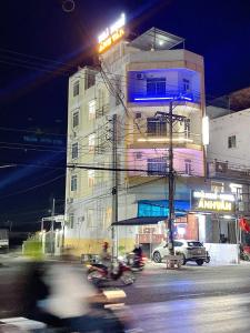 a building on a city street at night at ANH VAN Motel in Chau Doc