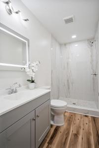 a white bathroom with a toilet and a shower at Cashmere Private Studio Cozy Chic Escape in Kokomo