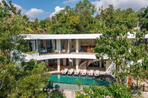 an aerial view of a house with a pool and trees at Villa Karilla in Toyapakeh