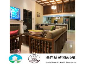 a living room with a couch and a tv at Kinmen Old Town Homestay in Jincheng