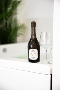 a bottle of wine and a glass on a table at Bosa Centro Rooms in Bosa +22 photos