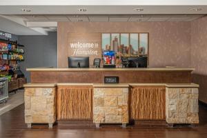 a welcome to hanlan counter in a store at Hampton Inn Austin Oak Hill in Austin