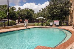 a large swimming pool with blue water at Hampton Inn Austin Oak Hill in Austin