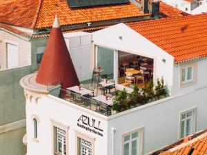 an aerial view of a white building with an orange roof at Alluz Nazare - Boutique Chalet By The Sea in Nazaré