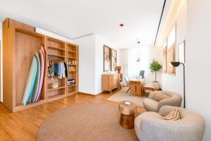 a living room with a surfboard on the wall at Alluz Nazare - Boutique Chalet By The Sea in Nazaré